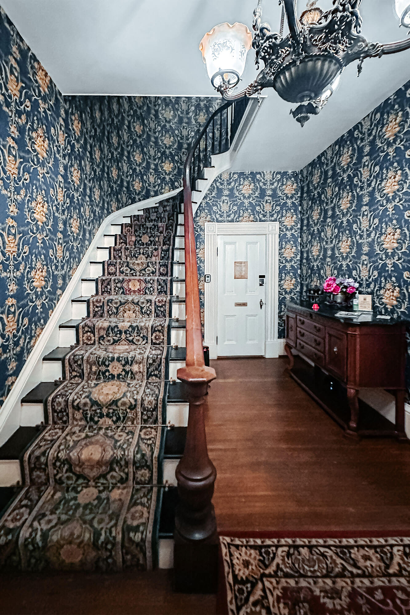 An inviting carpeted staircase leading upstairs in a historic location, setting the stage for a romantic escape.