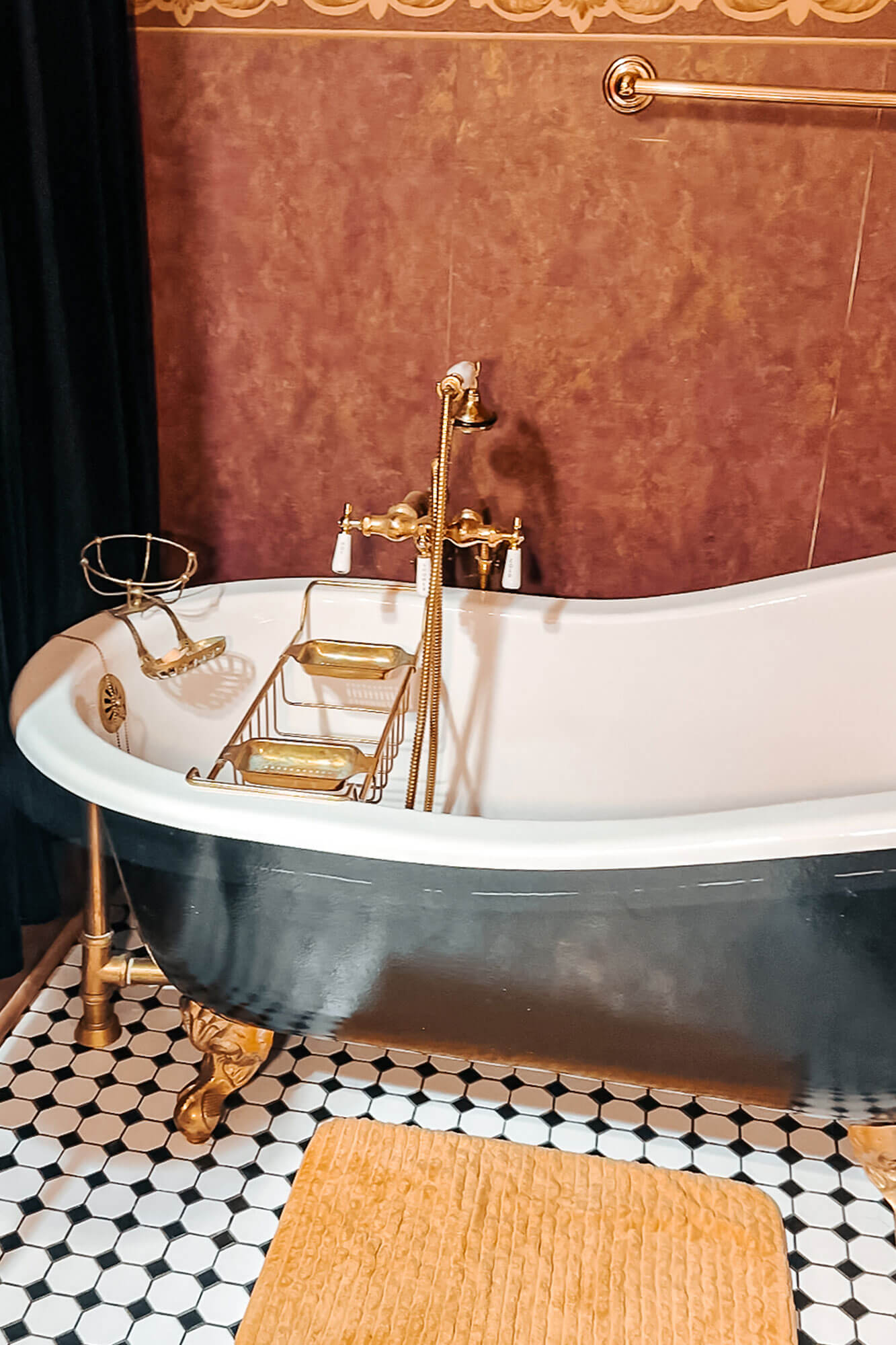 A vintage-style clawfoot tub in a romantically themed bathroom, perfect for a relaxing escape.